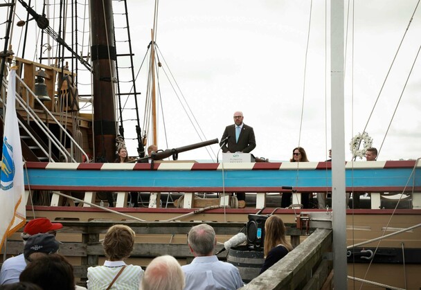 Dr. Peter Abbott OBE, British Consul-General in New England, delivers remarks from aboard Mayflower II.