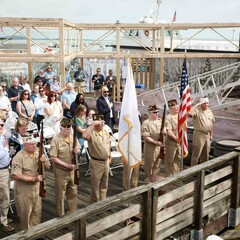 Veterans and guests stand for presentation of colors on dock at Mayflower II.