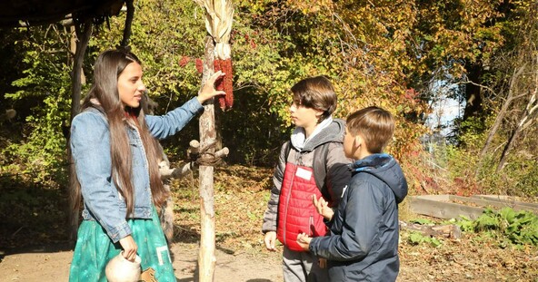 Museum Educator speaks with students on the Historic Patuxet Homesite.