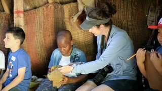 Students sit in a wetu with their teacher and learn about Wampanoag culture and lifeways.