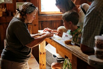 Plimoth Grist Mill Educator explains different grinds to guests.