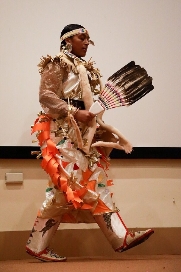 A member of Standing Quiver Singers dances on stage during the Winter Fine Arts and Crafts Fair.