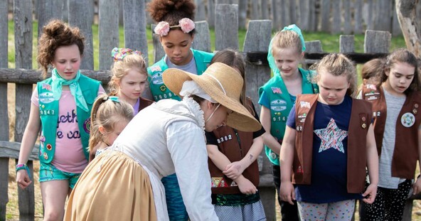Girl Scouts learn in the 17th-Century English Village from a Pilgrim woman.