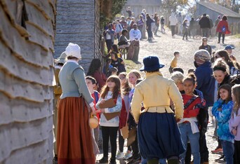 Crowds of Museum guests interact with Pilgrims at the 17th-Century English Village.