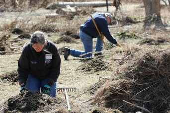 Trsutee volunteers hoemsite clean up day