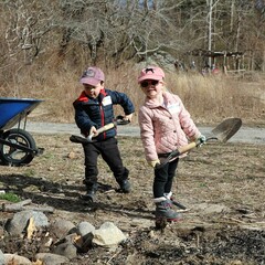 Young colunteers shoveling homesite clean up day