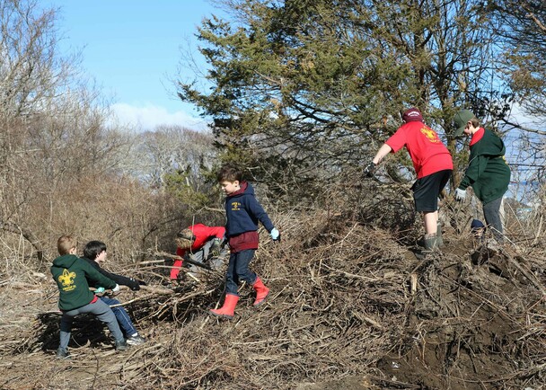 Young volunteers stick pile clean up day