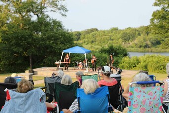 Guests sitting lawn chair indigenous voices series concert