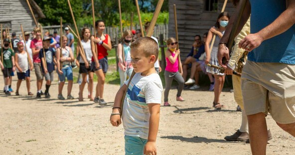 Child leads pike drill in 17th-century English Village