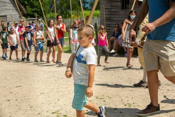 Child leads pike drill in 17th-century English Village