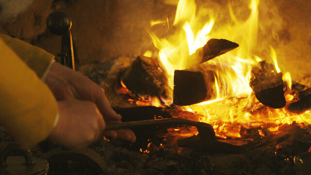 English village hearth tending fire