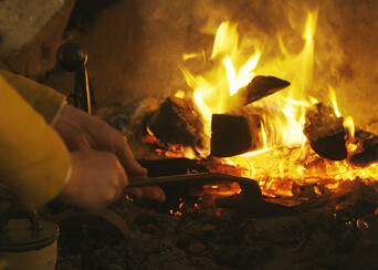 English village hearth tending fire