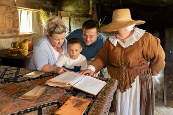 Family reading alongside Pilgrim