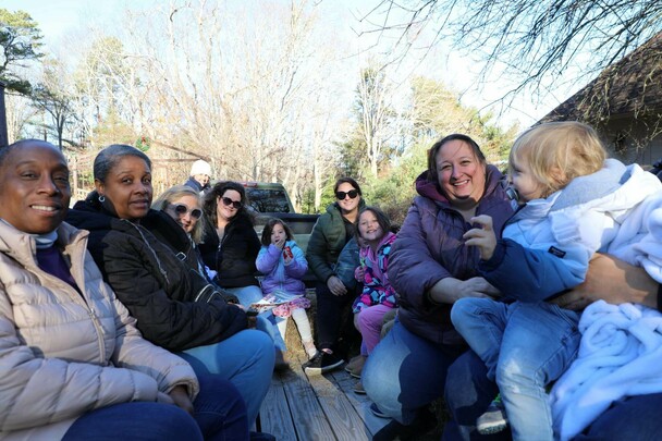 A group of people seated on a hayride.