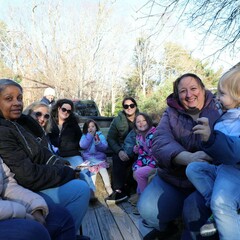 A group of people seated on a hayride.