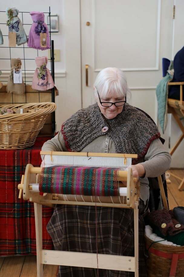 Woman weaves at the Winter Fair.