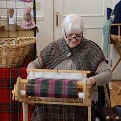 Woman weaves at the Winter Fair.