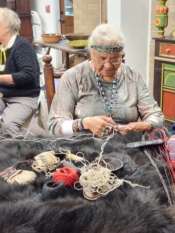 Indigenous Museum Educator demonstrates Indigenous craft