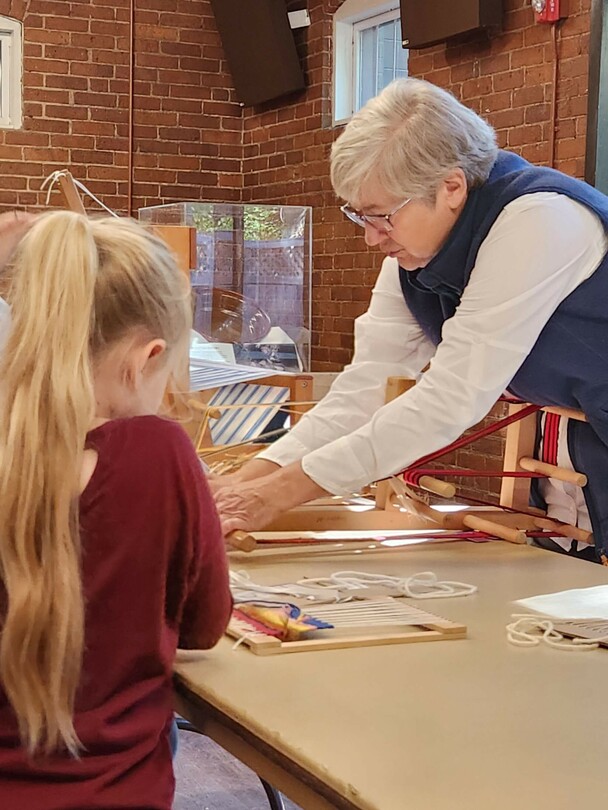 Volunteer sets up learning activity for children.