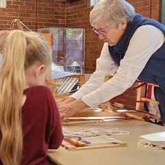 Volunteer sets up learning activity for children.