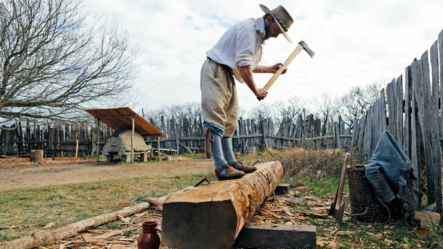 English village pilgrim working log axe chopping wood