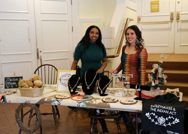 The founders of Juniper and Pine Collective stand behind their table featuring handmade items at the Winter Fine Arts & Craft Fair.