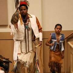 An adult and child member of Wetu Ways demonstrate a traditional dance in Plimoth Cinema.