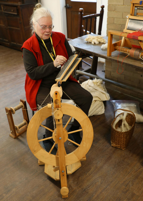 A textile artisan demonstrates her craft.