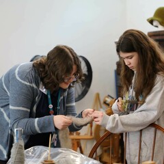 An Educator and young learner examine wool at the Craft Center.