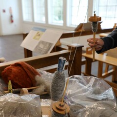 Educator spins wool in Craft Center.