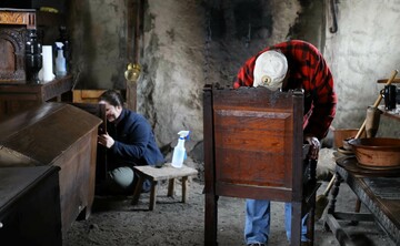 Volunteers polish pilgrim furniture