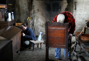 Volunteers polish pilgrim furniture