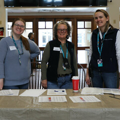 Three staffers stand ready to check-in Museum Clean Up Day Volunteers