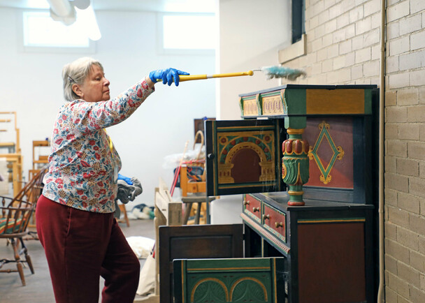 Volunteer dusting craft center