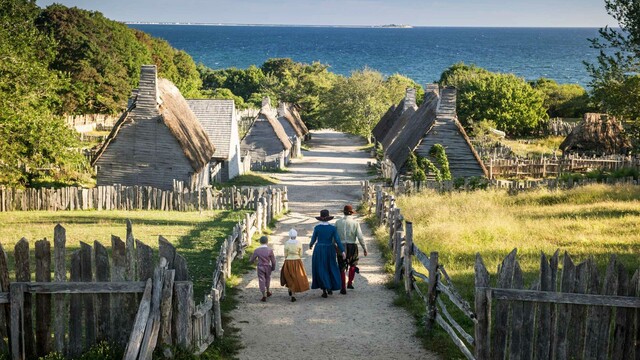 Pilgrim family walks down main path of the 17th-Century English Village