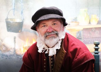 Man in Pilgrim Dress In Front of hearth