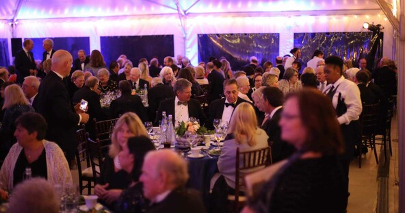 Guests enjoy dinner at an evening event
