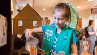 Scout pours water in educational activity at Plimoth Grist Mill