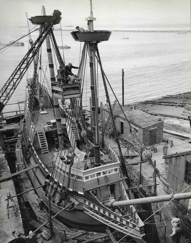Men work on Mayflower at dock