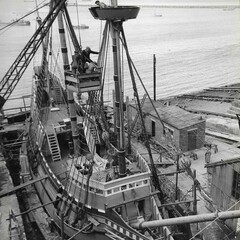 Men work on Mayflower at dock