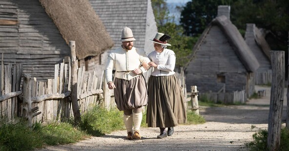 Pilgrim couple walks down village path