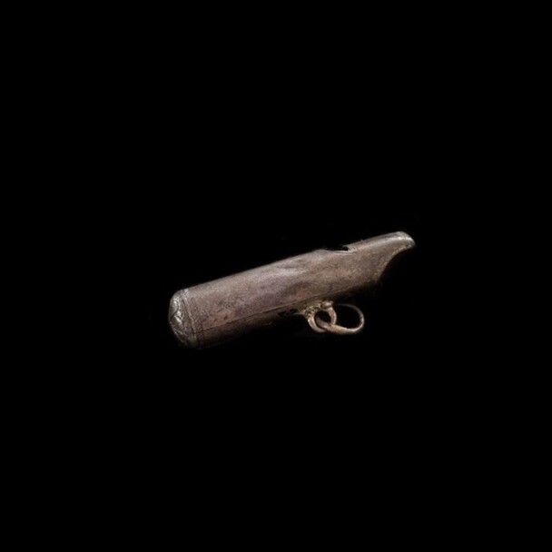 A whistle found at the Winslow Site. It is etched with a roulette design and has the initials "EW" incised on the mouth piece.