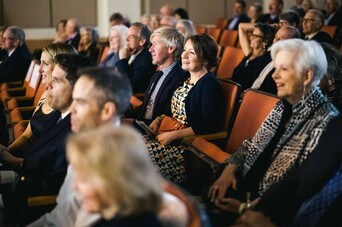 Crowd seated in a movie theater looking towards the screen