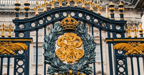 Buckingham Palace iron gates with gold details and royal symbols