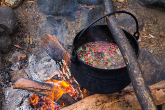 Turkey sabaheg cooks in a pot over an outdoor fire