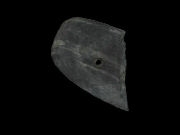 Half of a broken, oval-shaped, banded slate gorget with one hole drilled into it