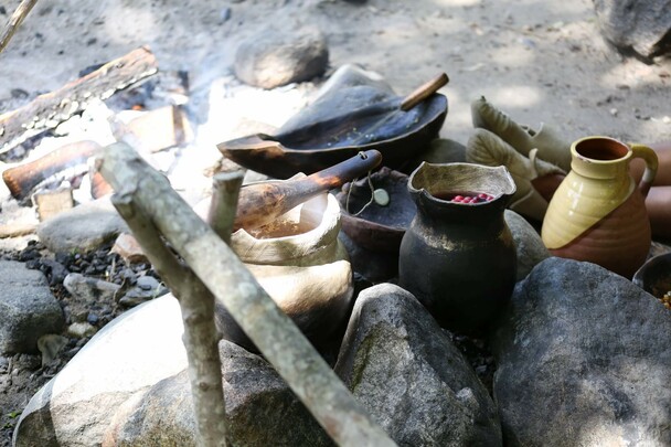 Wampanoag cooking pot set over a fire outdoors