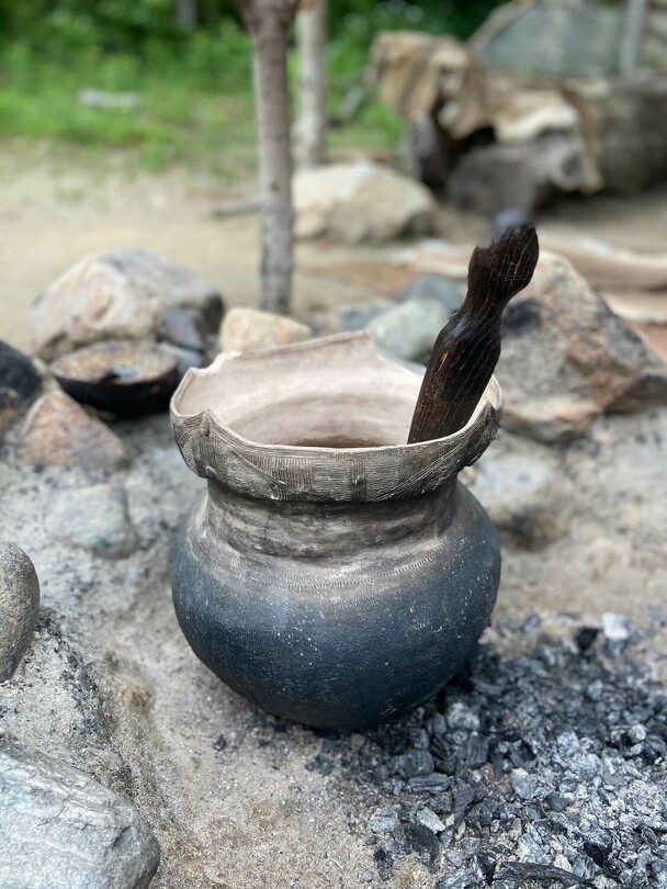 A Wampanoag cooking pot set in an outdoor cooking arbor