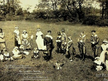 Children dressed in costume in a field dressed to replicate a Plymouth scene.