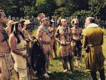 Museum educators dressed in regalia and a man in Pilgrim dress reenact the wedding of William Bradford